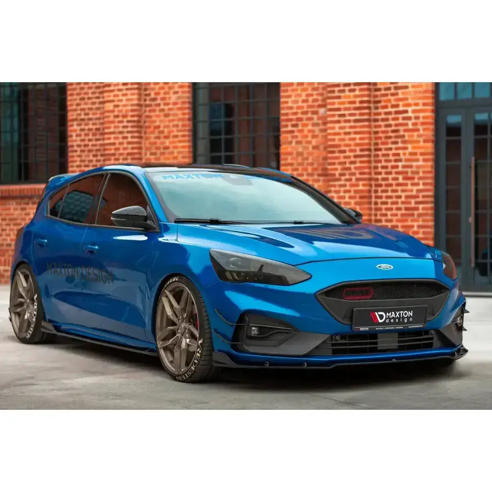 Front lip på Ford Focus Mk4 St-Line i blått med sorte detaljer og store felger utendørs.