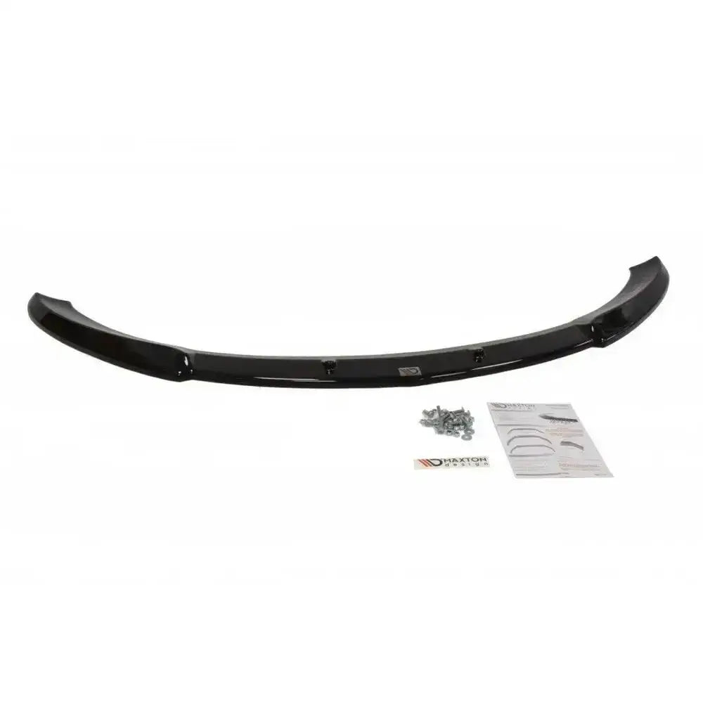 Front splitter Mazda Cx-7 sort plast med skruer og instruksjonsark sett ovenfra på hvit bakgrunn.