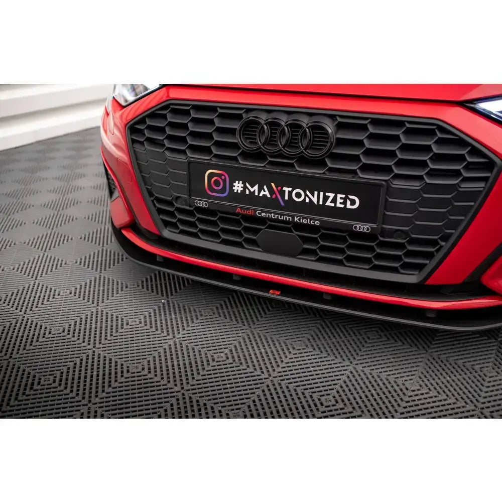 Front lip Street Pro Audi A3 8Y med sort bikubemønstret grill og røde detaljer på bilens front.