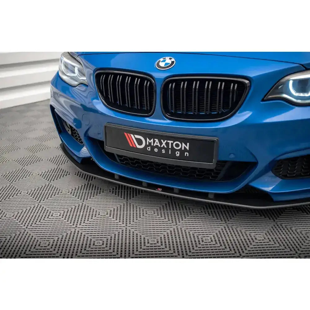 Frontsplitter på BMW 2 Serie M-Pack F22 med sort grill og LED-lykter, sett forfra på rutet gulv.