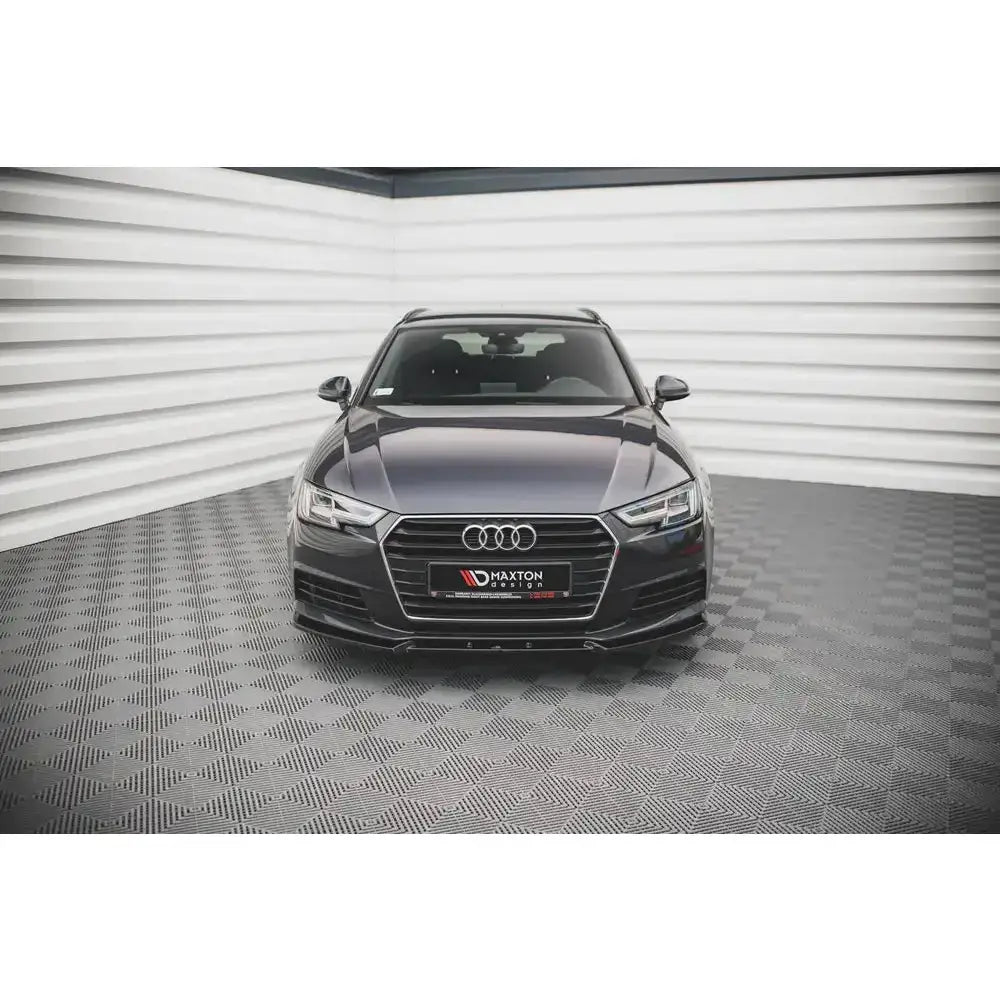 Frontspoiler på Audi A4 B9 Sedan V.1, mørk grå bil sett forfra med forkrommet grill og logo.
