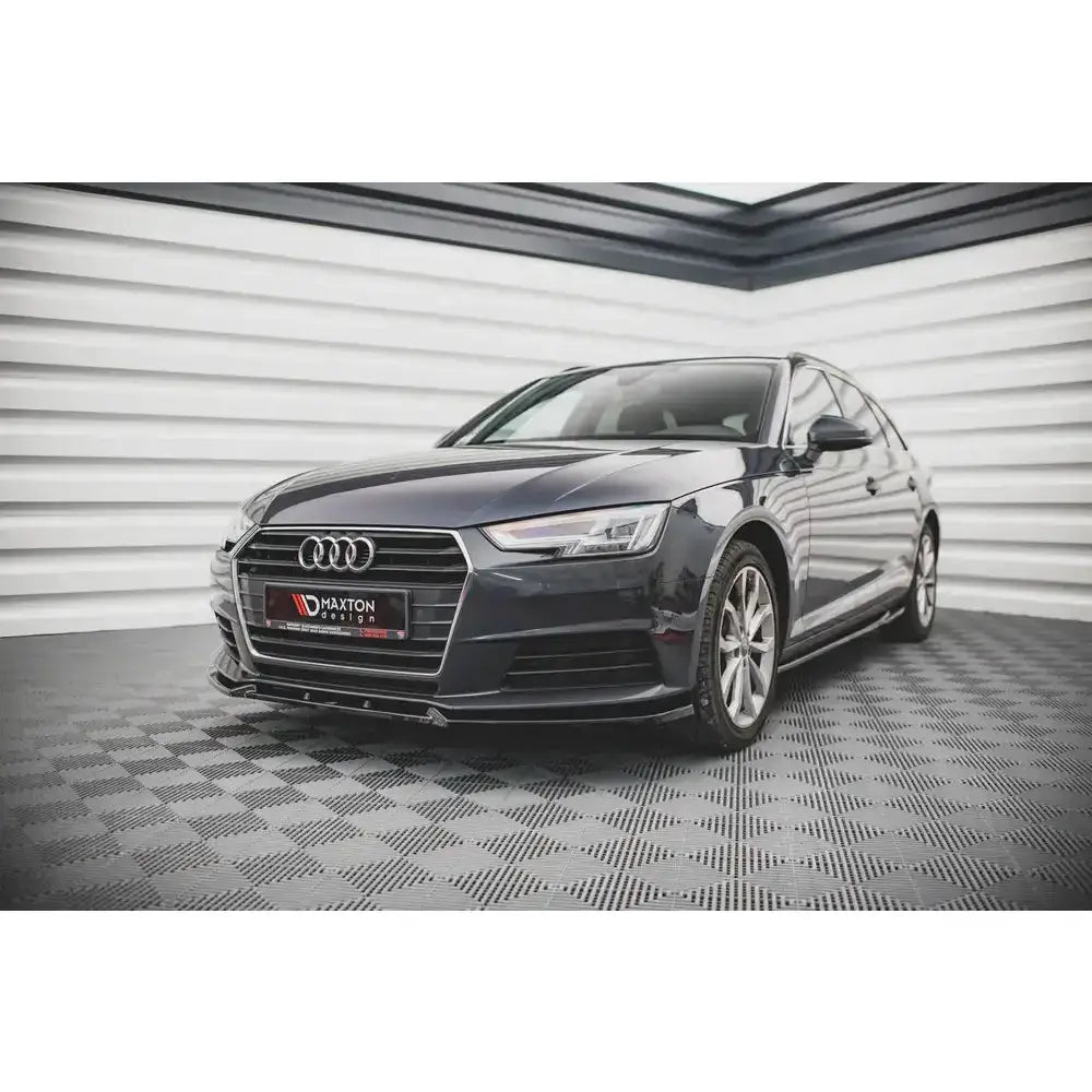 Front lip på Audi A4 B9 med sølvfelger, kromgrill og sportslig front, fotografert fra lav vinkel.