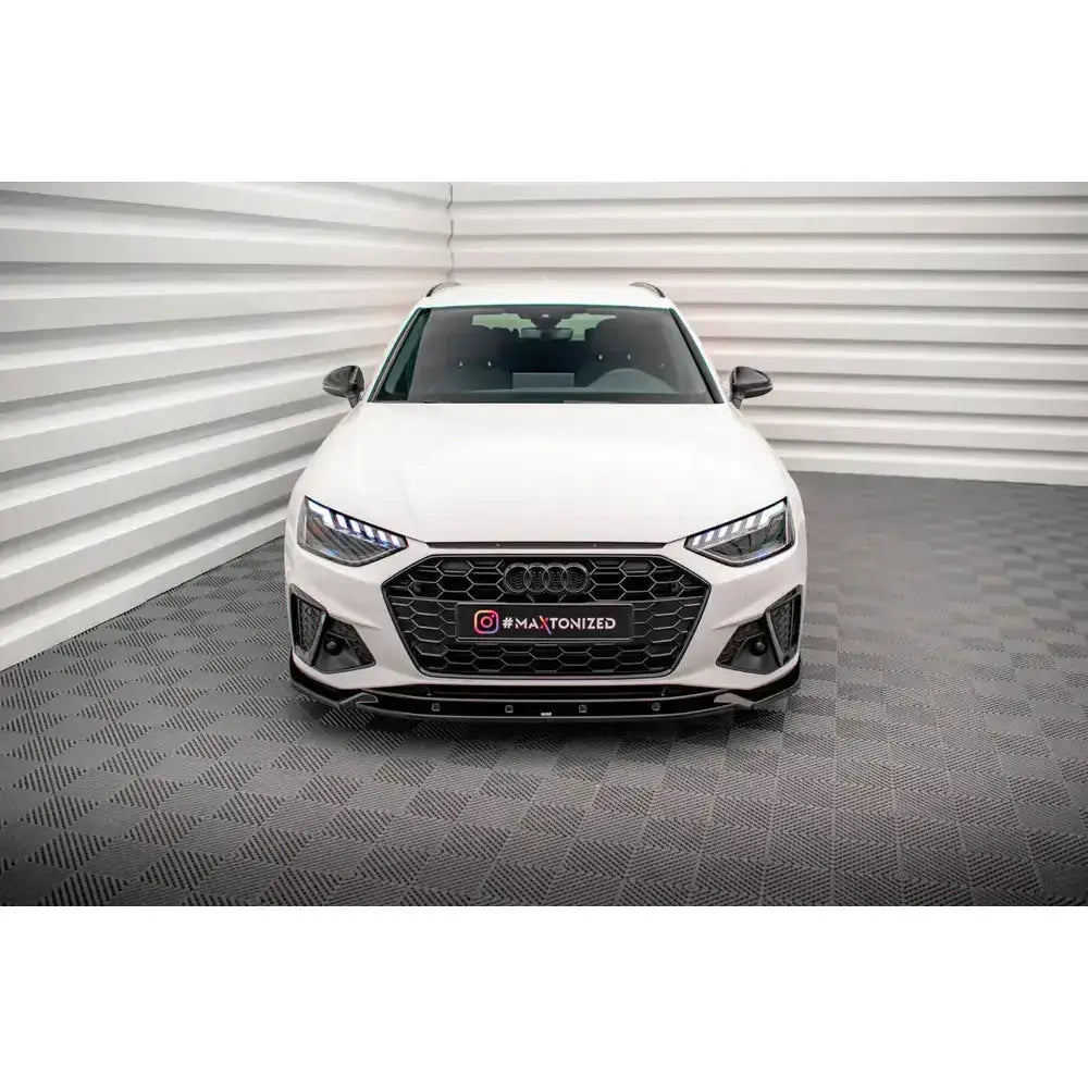 Frontspoiler på hvit Audi A4 S-Line B9 Facelift sett forfra med sort grill og LED-lykter.