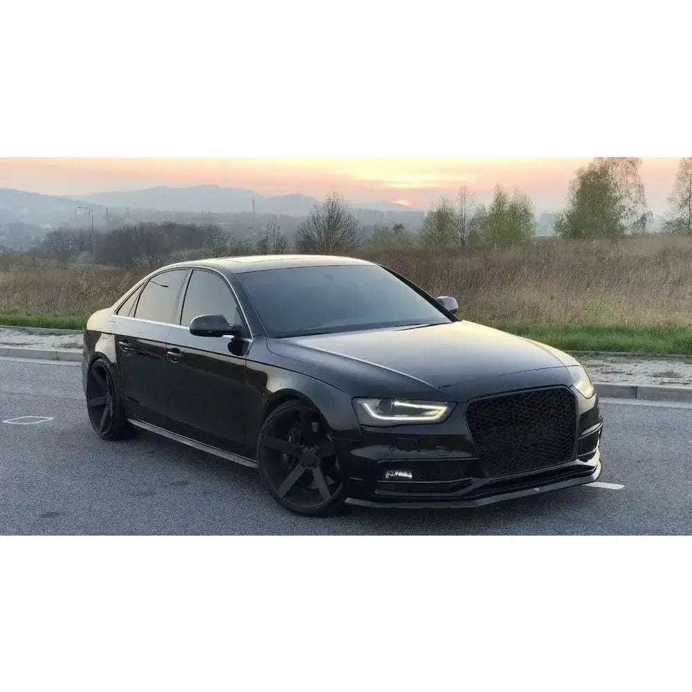 Frontspoiler på Audi S4 B8 FL sedan med sotede ruter og svarte felger, parkert utendørs ved solnedgang.