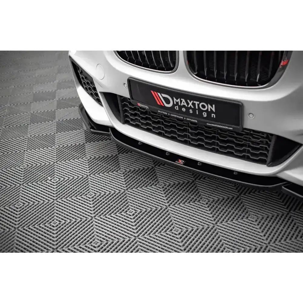 Frontsplitter til BMW X1 M-Pack F48, sort design montert på hvit bil med Maxton-logo synlig.
