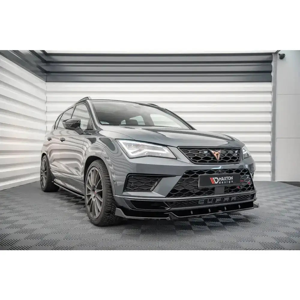 Frontsplitter på Cupra Ateca V.1, grå SUV med sorte felger og markerte luftinntak innendørs.