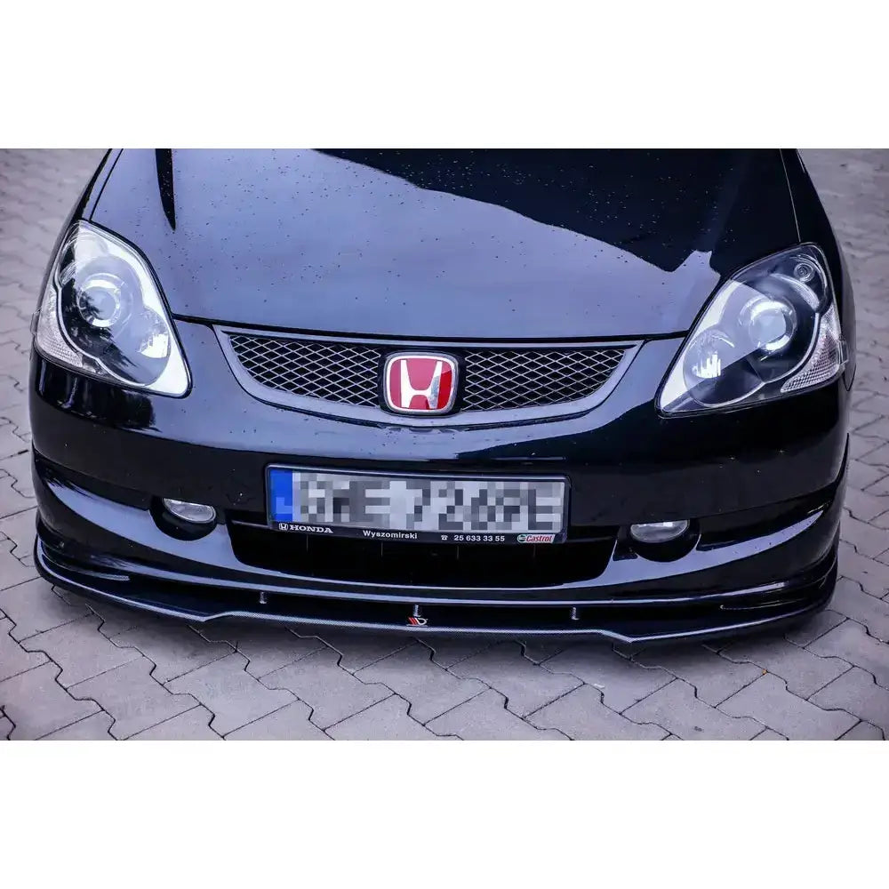 Frontsplitter på Honda Civic EP3 Type-R facelift med rød logo og sort frontleppe montert under grillen.