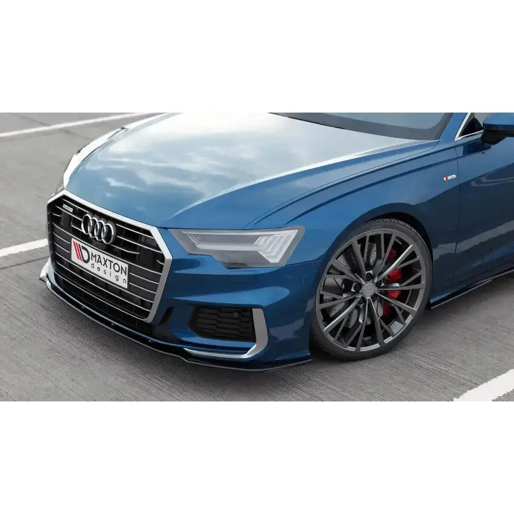 Frontsplitter på Audi A6 S-Line med svart spoiler, store sorte felger og røde bremsekalipere.