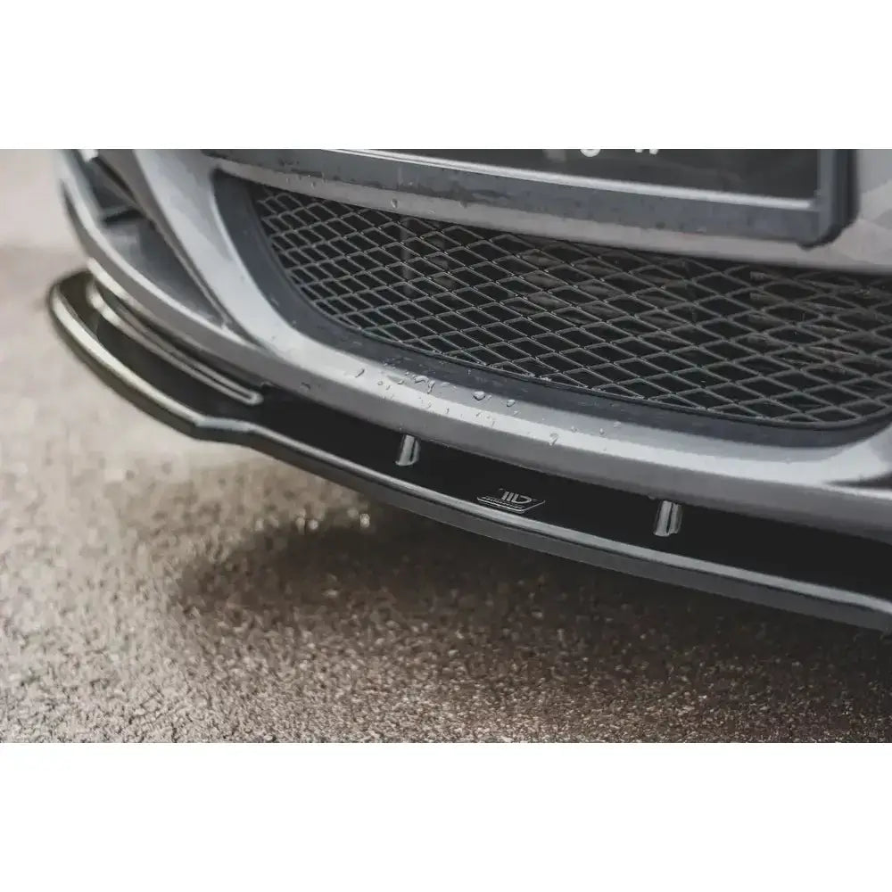 Frontleppe V.2 til BMW 3 E90/E91 Facelift i sort plast med logo og vanndråper, nærbilde på grå bil.