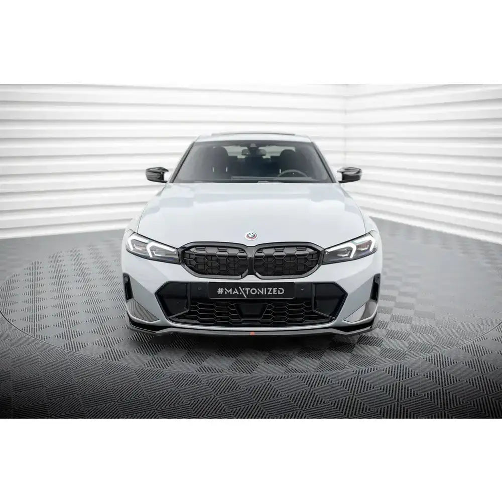 Frontspoiler på BMW 3 M340i G20 Facelift med sort grill og sportslige detaljer, sett forfra.
