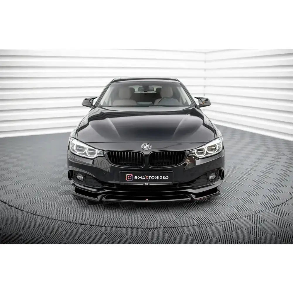 Frontspoiler på svart BMW 4 Gran Coupe F36 vist forfra med markante frontlykter og sort grill.