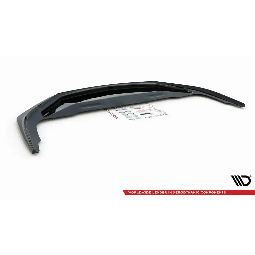 Frontsplitter til Porsche 911 Carrera 991 V.2 i blank sort plast med monteringsutstyr på hvit bakgrunn.