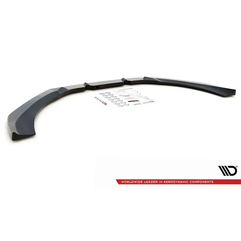 Frontspoiler til Audi RS6 C7 V.3, svart buet plast med monteringsutstyr og klistremerker på hvit bakgrunn.