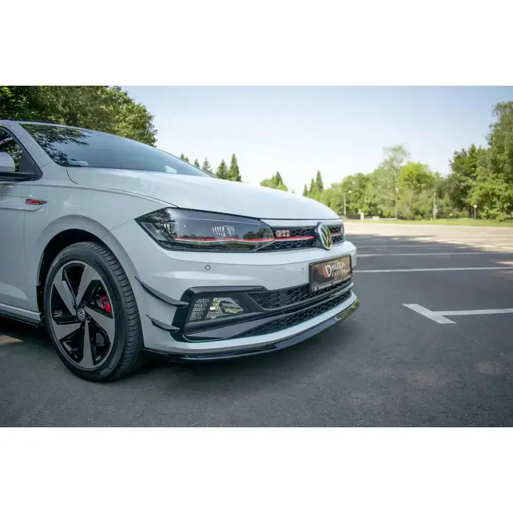 Front splitter på VW Polo GTI MK6, hvit bil med svarte og røde detaljer og sporty aluminiumsfelger.