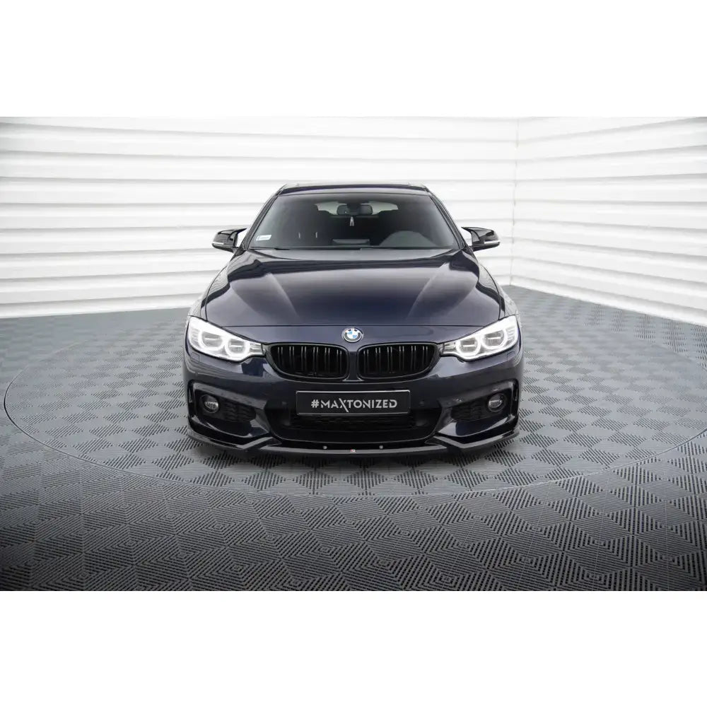 Frontsplitter på mørkeblå BMW 4 Gran Coupe F36 M-Pack sett forfra med LED-lykter og sort grill.