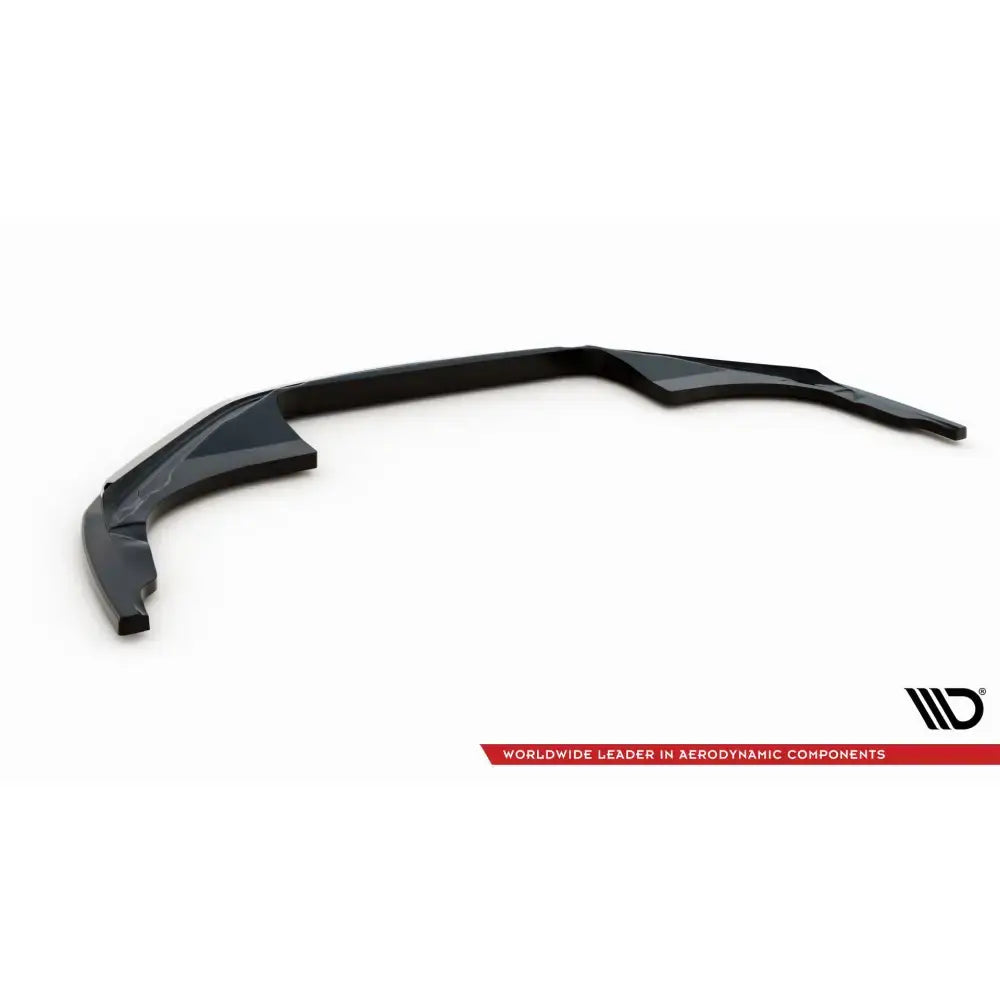 Frontspoiler til Porsche 911 Carrera Aero 992 i sort, glanset plast sett skrått ovenfra mot hvit bakgrunn.
