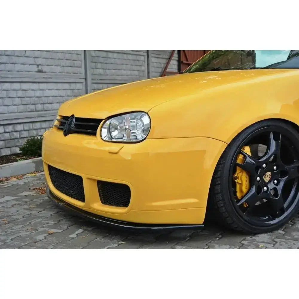 Front lip på VW Golf IV R32 vist fra siden med svarte felger og gule bremsekalipere.