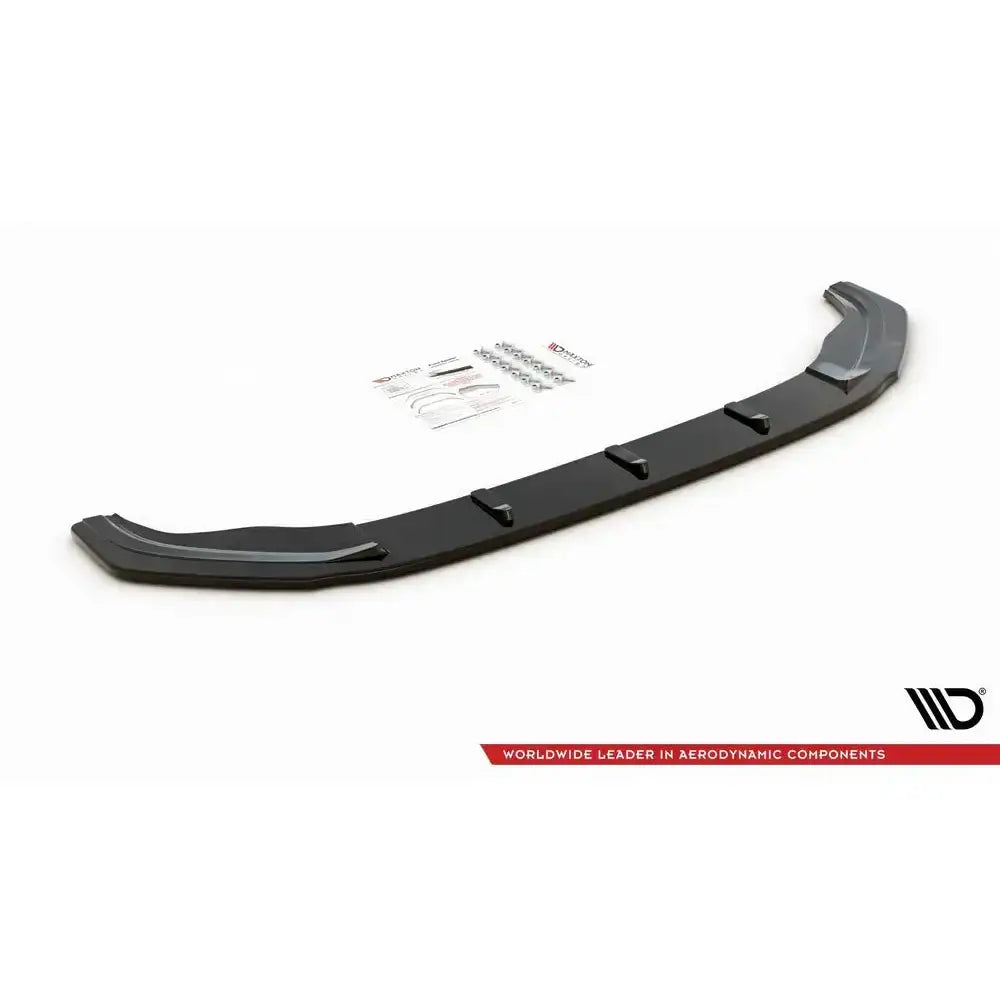 Frontspoiler til VW Golf VII GTI i sort plast med monteringssett og instruksjoner på hvit bakgrunn.
