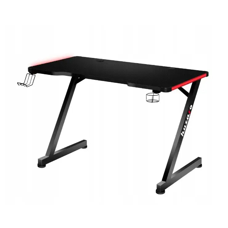 Gamingbord Huzaro Hero 4.7, skrå vinkel som fremhever røde kanter, koppholder og hodetelefonkrok på sidene.