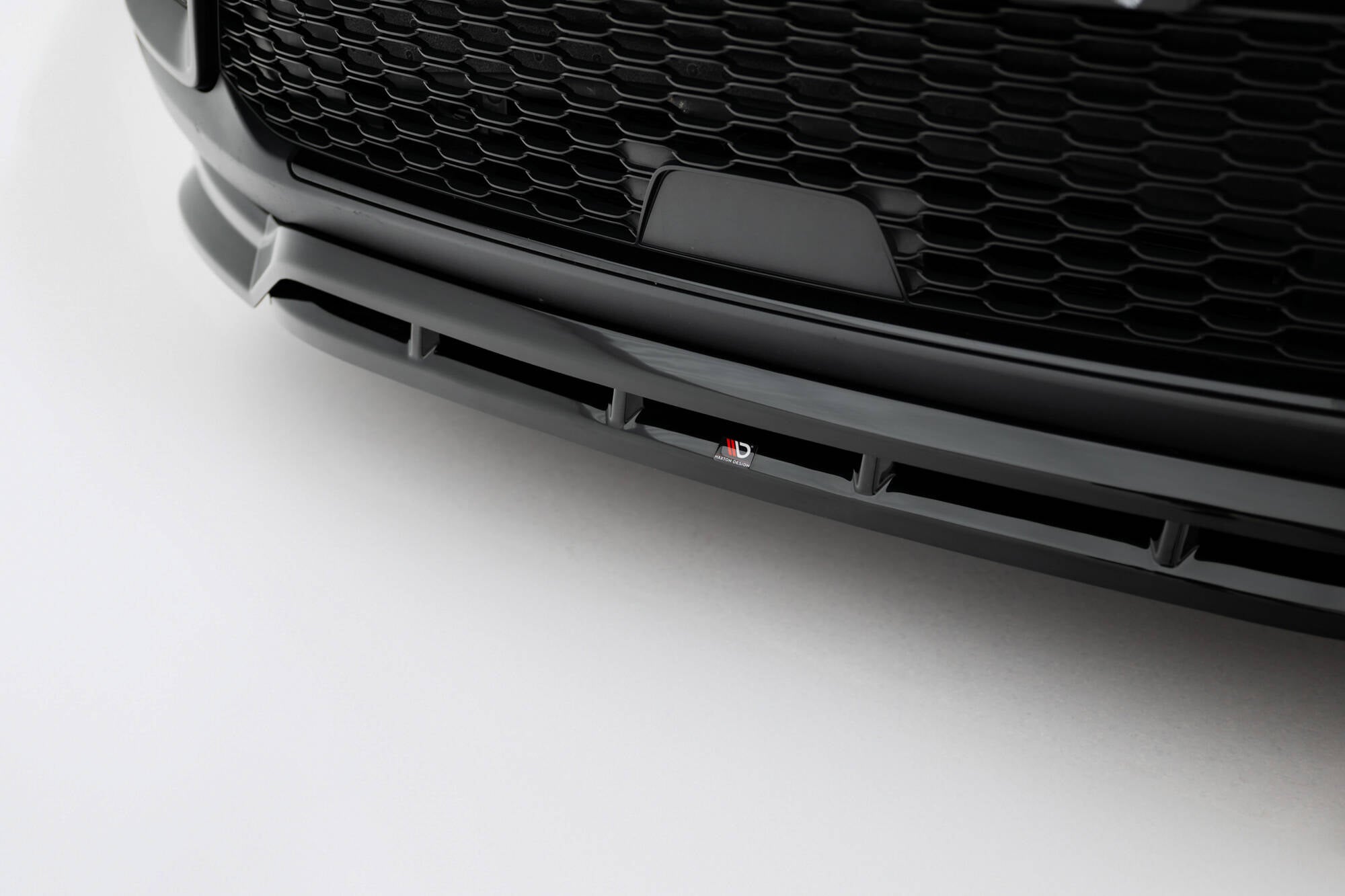 Spoiler til Jeep Grand Cherokee Trailhawk MK5 i sort plast med bikubemønstret grill og logo foran.