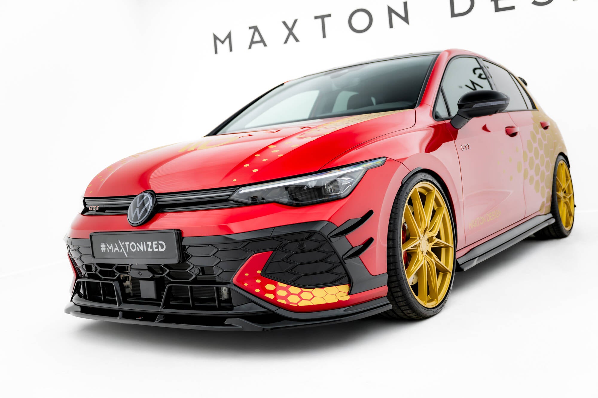 Frontspoiler VW Golf GTI Clubsport MK8 Facelift med gyldne felger og markert frontsplitter mot hvit bakgrunn.