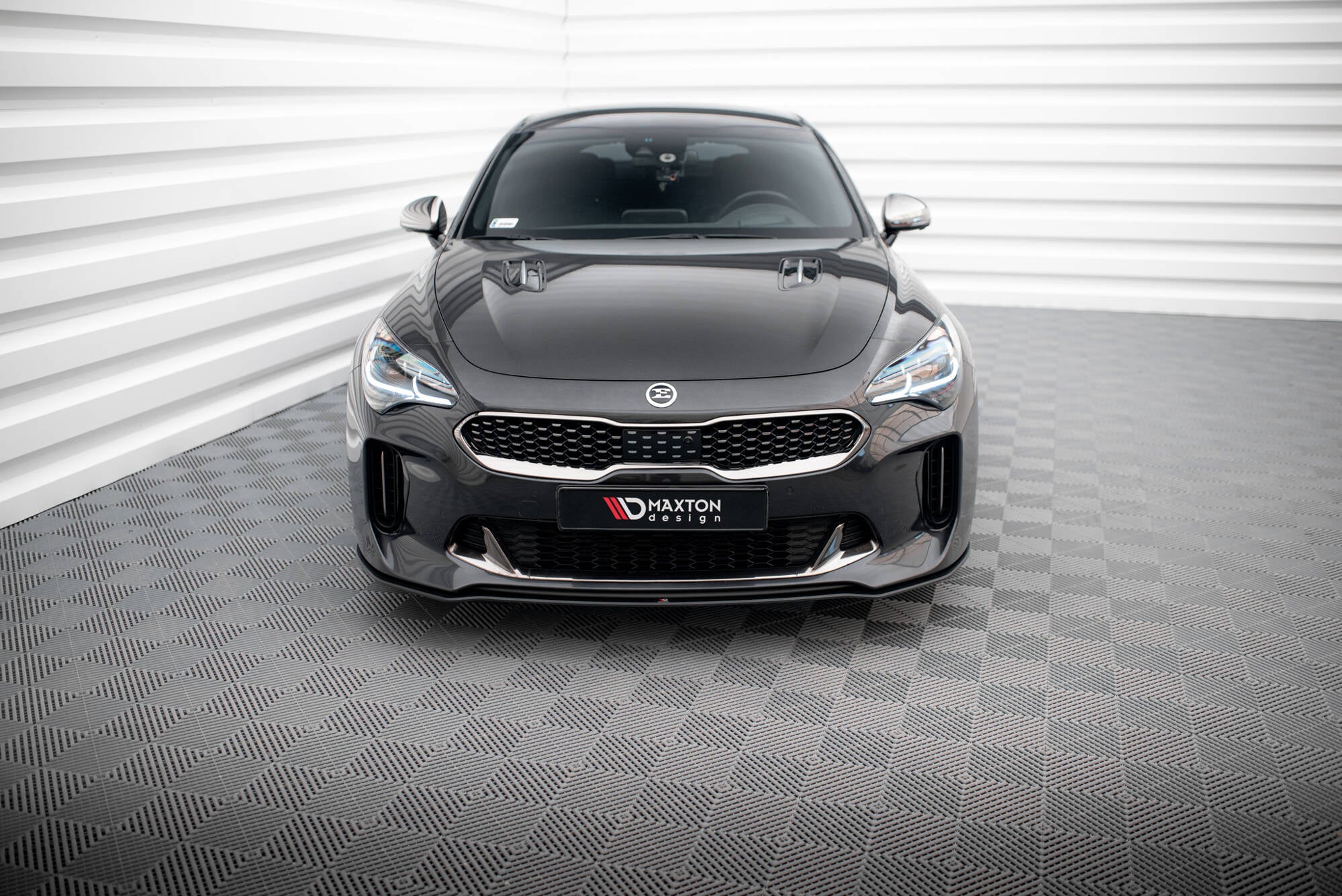 Frontleppe på Kia Stinger GT MK1 2017-2023 med sort grill og Maxton Design-logo foran hvit bakgrunn.