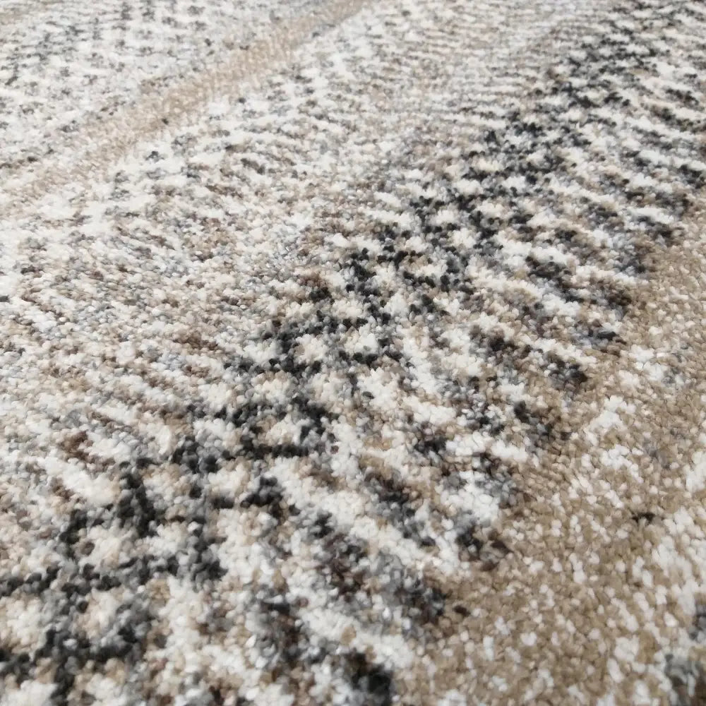 Tepe Moderne Panamero 12, nærbilde som fremhever teppets myke, tykke fibre og beige-grå mønsterstruktur.