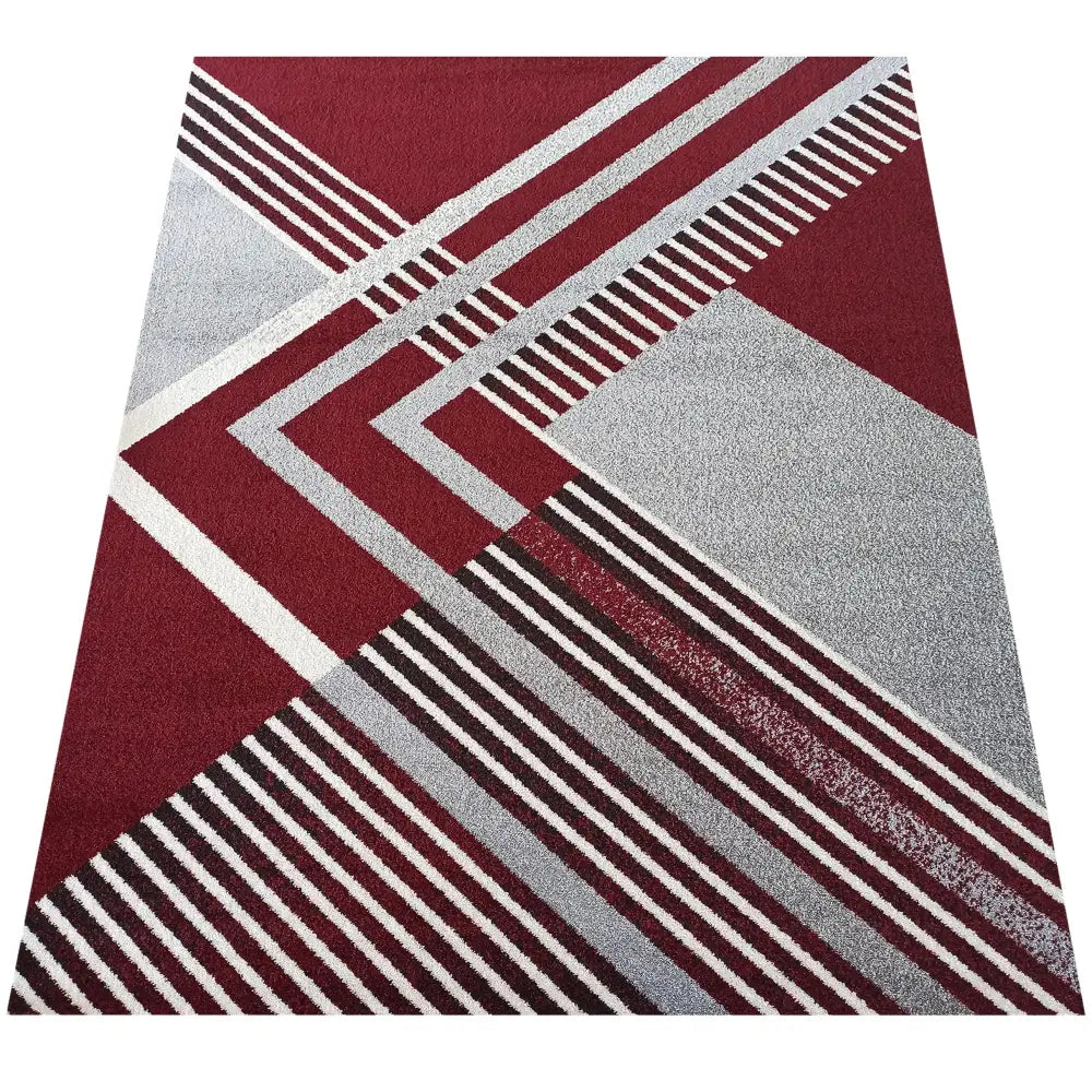 Tepe Otto teppe 200 x 290 cm, sett ovenfra med rødt og grått geometrisk mønster og moderne linjer.
