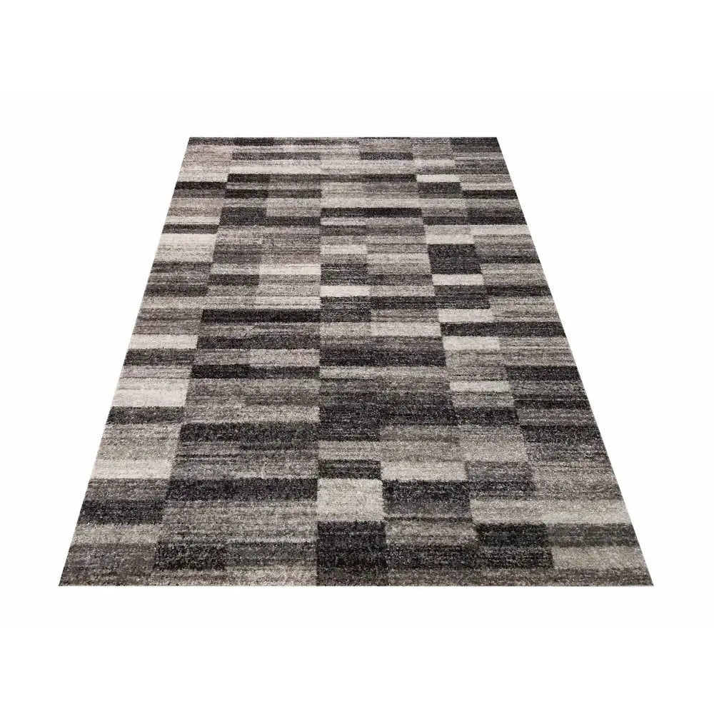 Tepe Panamero teppe i grått, rektangulært rutemønster med svarte felt, sett ovenfra mot kortsiden.