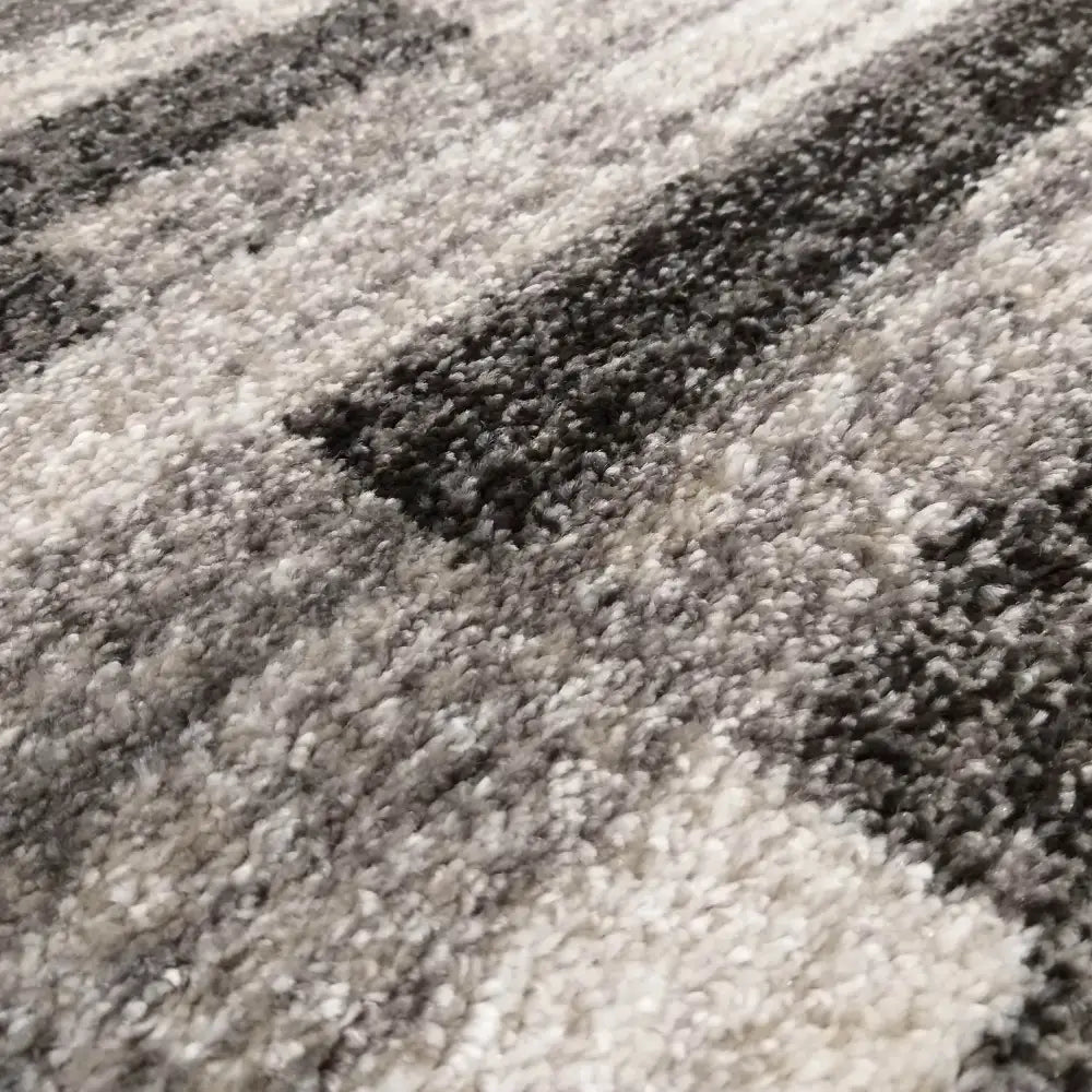Tepe Panamero teppe i grått, detaljert nærbilde som viser stripet mønster og synlig, myk tekstur.