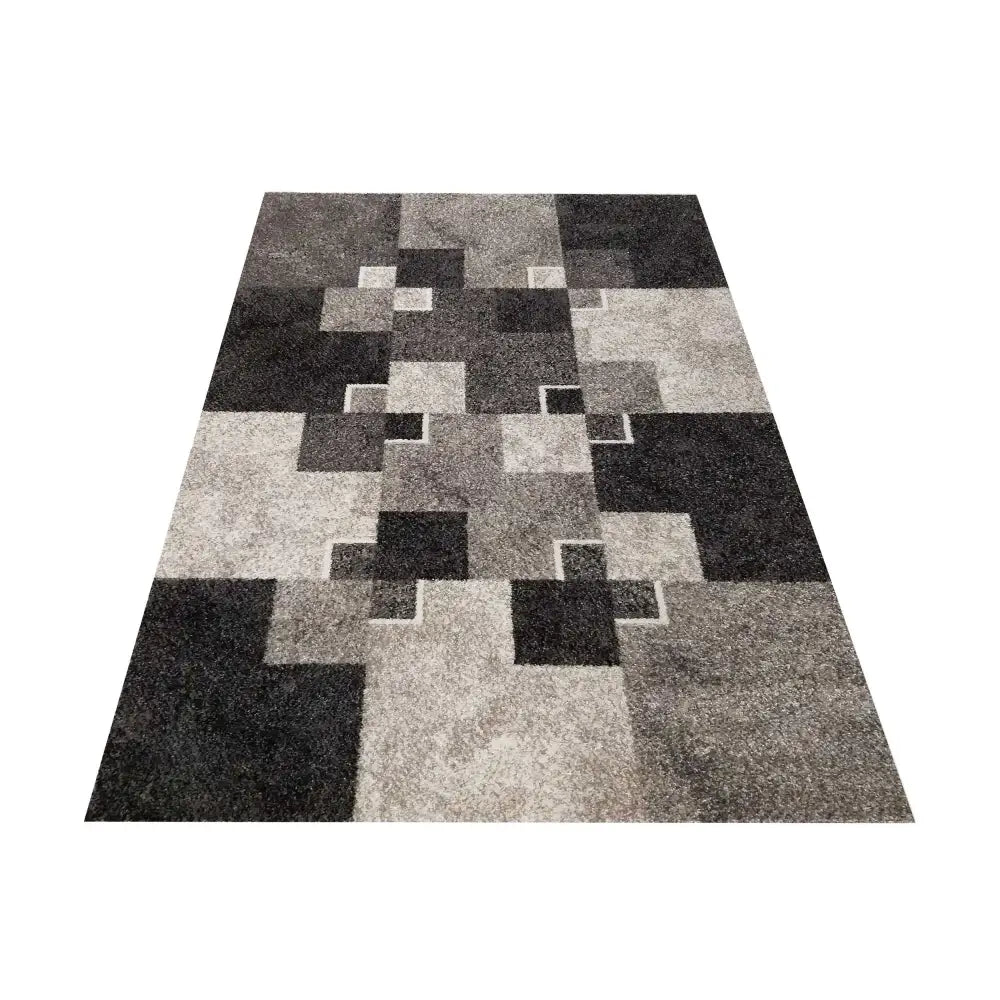 Tepe Panamero teppe i gråtoner, geometrisk mønster med firkanter og rektangler, sett skrått ovenfra.