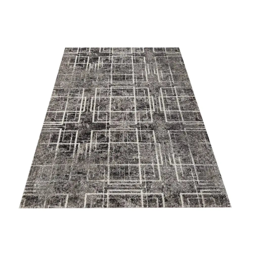 Grått Tepe Panamero-teppe 200 x 290 cm, sett ovenfra med hvite geometriske firkanter og tett, myk tekstur.